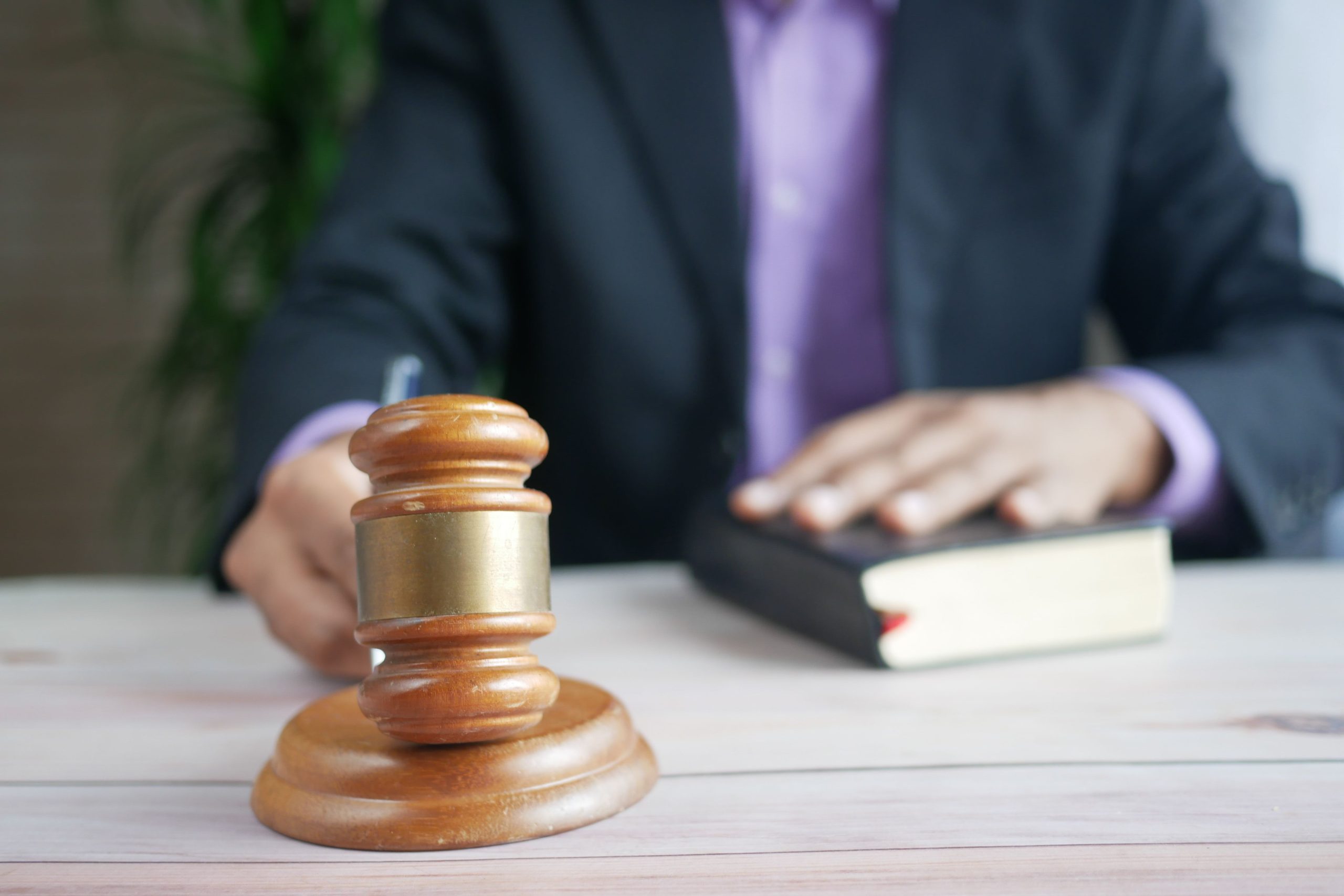 Wooden gavel and legal book representing justice and legal authority in a court setting