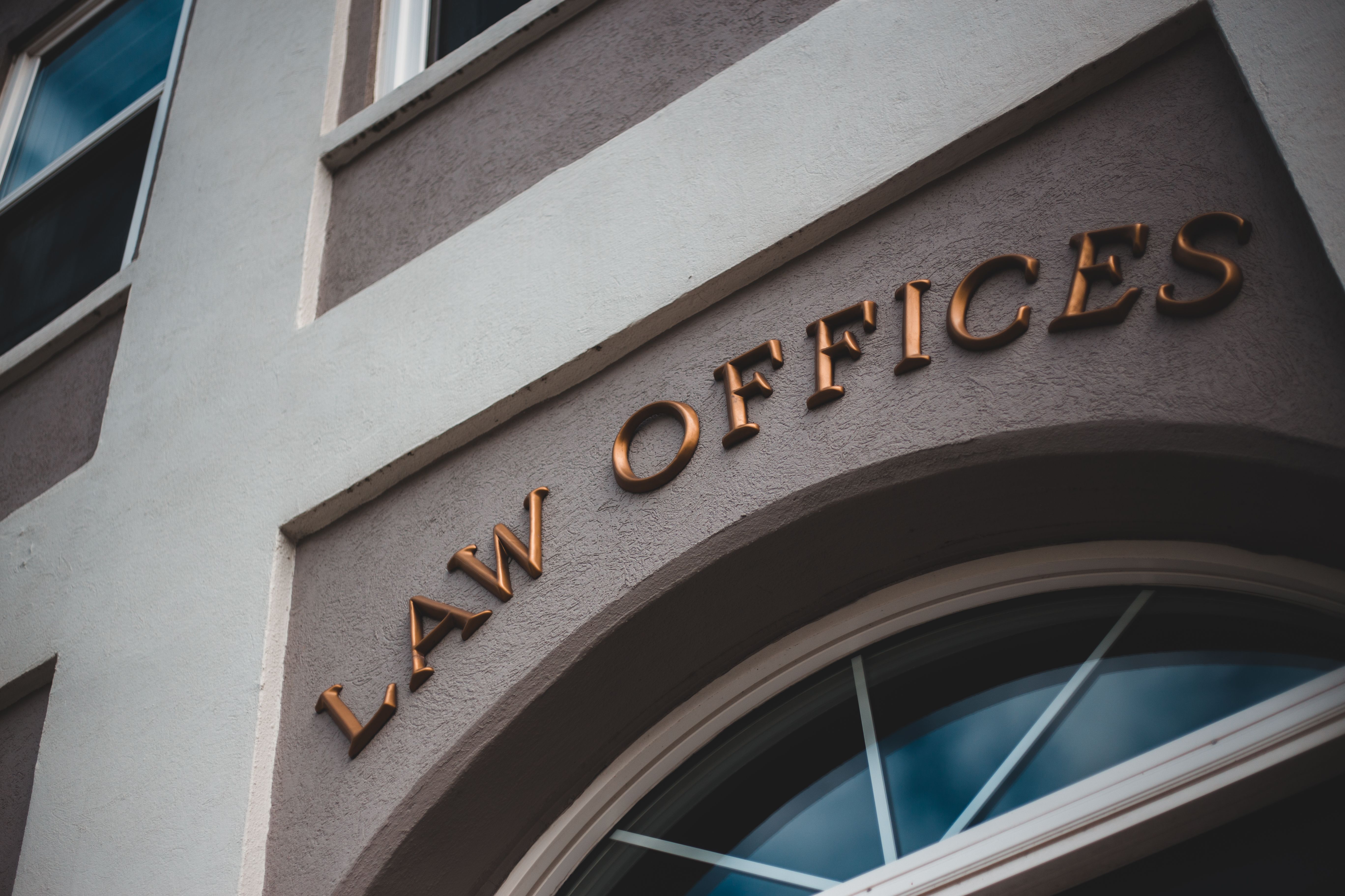 Modern law firm office building exterior with an elegant facade and arched entrance